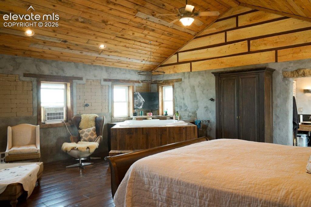Image 42 of 50: Vaulted wood-plank ceiling with recessed lighting and ceiling fan