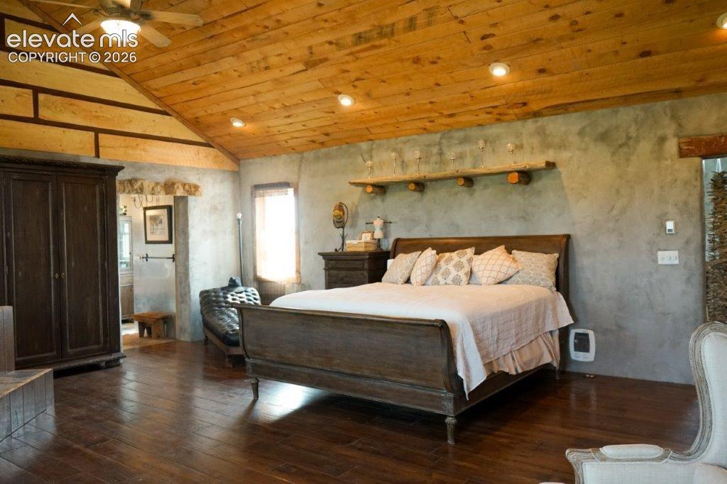 Image 43 of 50: Vaulted wood-plank ceiling with recessed lighting and ceiling fan