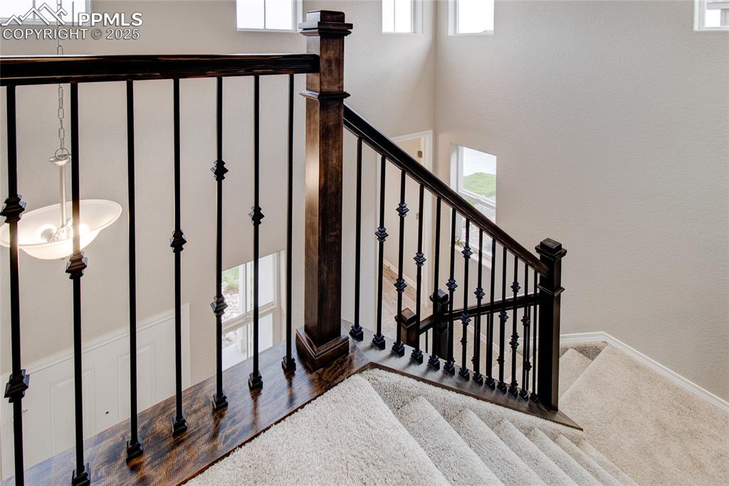 Image 13 of 24: Stairway with wood finished floors