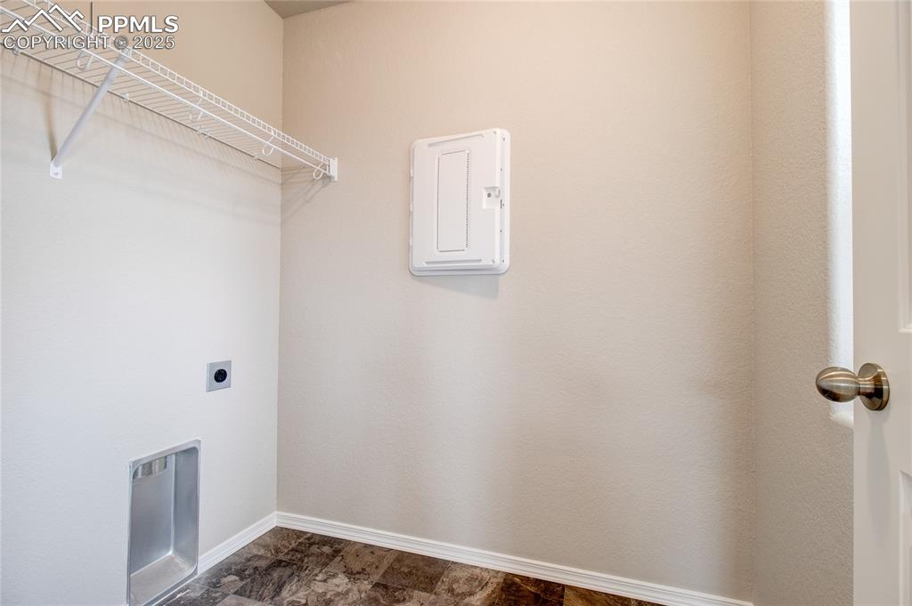 Image 14 of 24: Laundry room featuring hookup for an electric dryer and stone finish floori