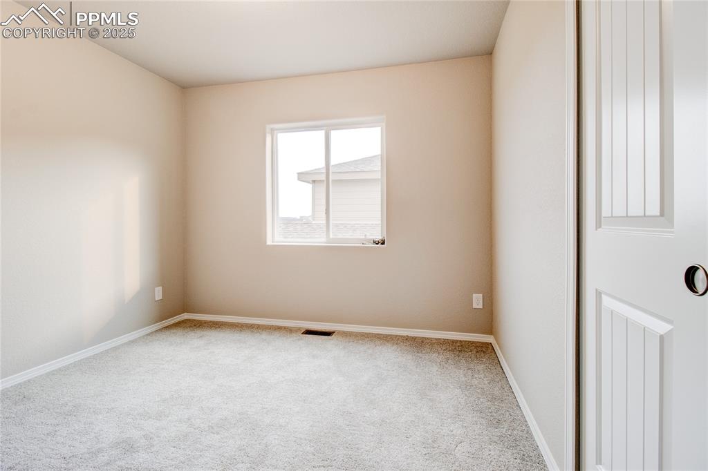 Image 22 of 24: Carpeted spare room featuring baseboards
