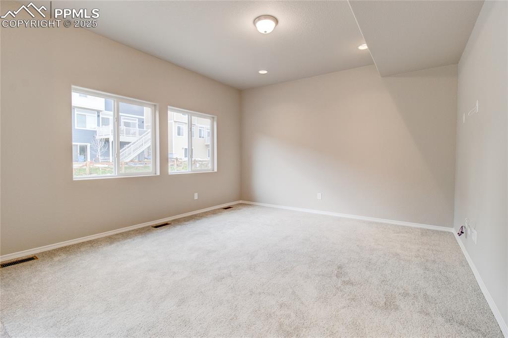 Image 9 of 24: Spare room with carpet floors and recessed lighting