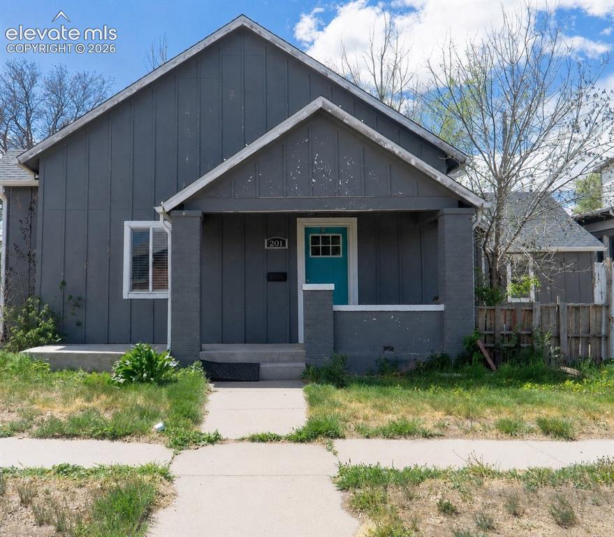 Image 1 of 27: Single-story residence featuring a covered front porch with brick columns, 