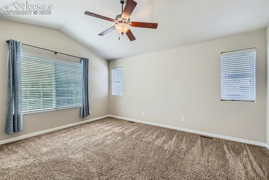 Image 18 of 31: Carpeted spare room with lofted ceiling and ceiling fan