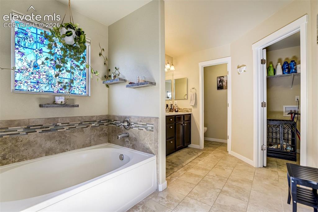 Image 17 of 42: Primary bath has access to the laundry room.