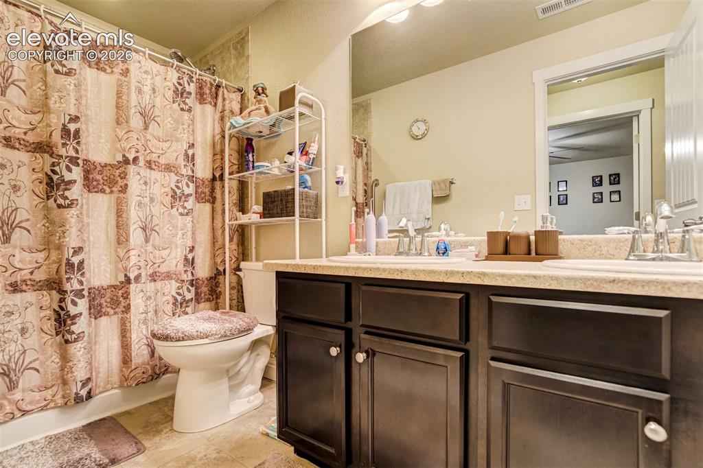 Image 35 of 42: Basement bathroom also has a dual vanity.