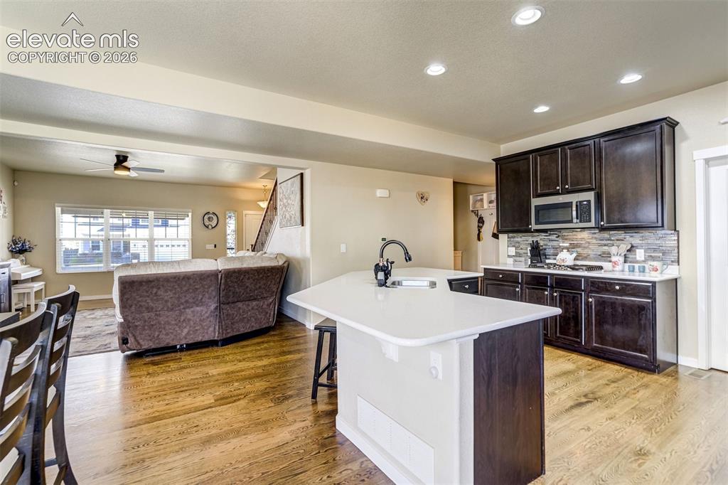 Image 9 of 42: Large island in kitchen, with elegant quartz countertops.
