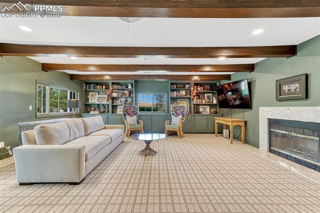 Image 19 of 50: A beautifully redesigned library/media room, showcasing a complete and cohe