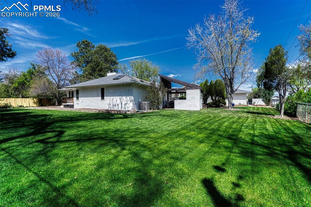 Image 39 of 50: Beautifully curated .63-acre grounds feature level lawn
