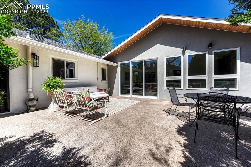 Image 40 of 50: The kitchen opens to a generous patio designed for effortless entertaining,