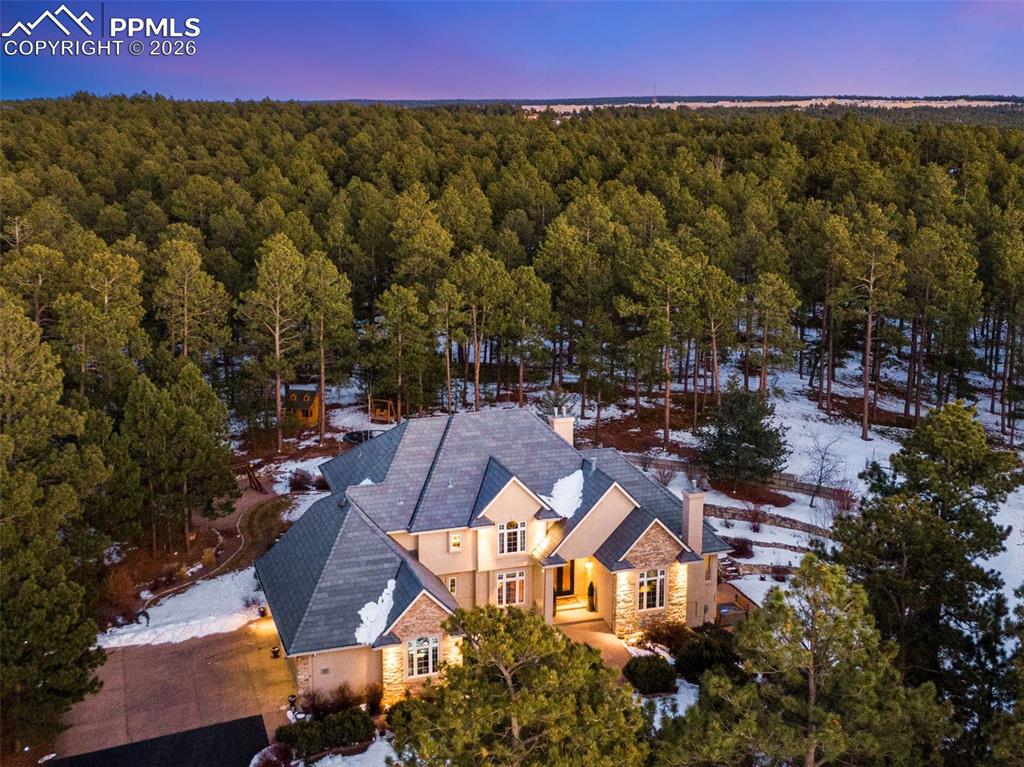 Caption: Aerial view of home that sits on 2.5 acre treed property