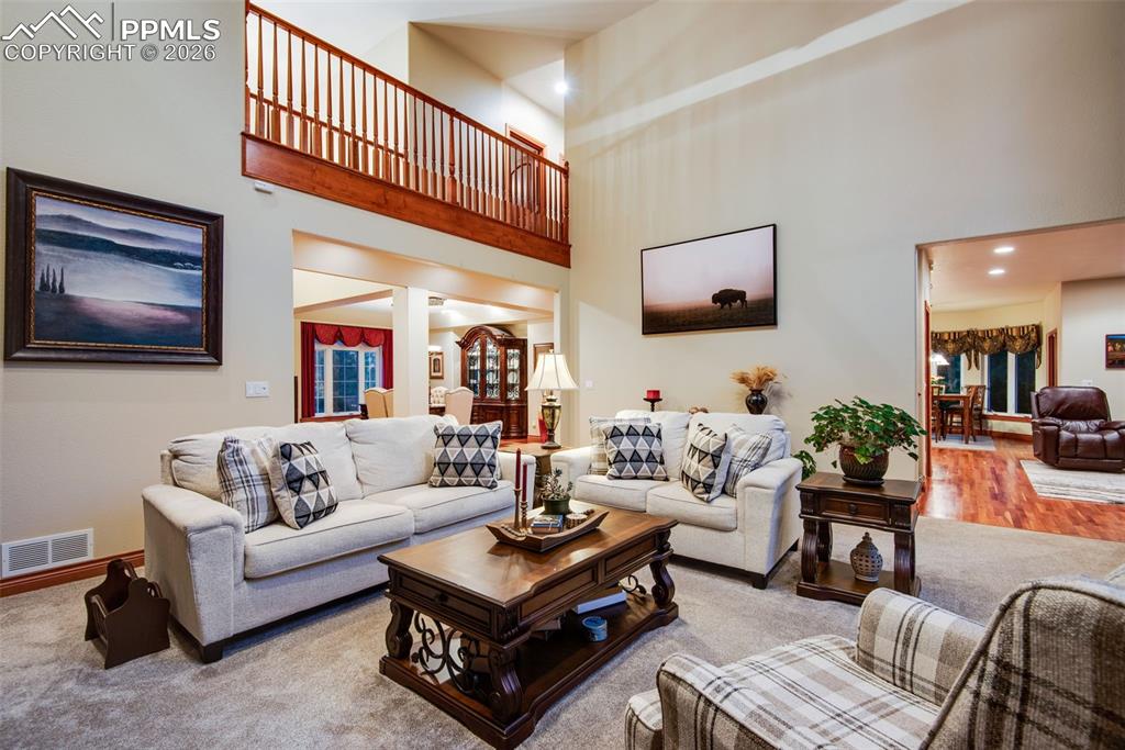 Image 14 of 42: Living room from another view looking up at the catwalk hall to the upstair