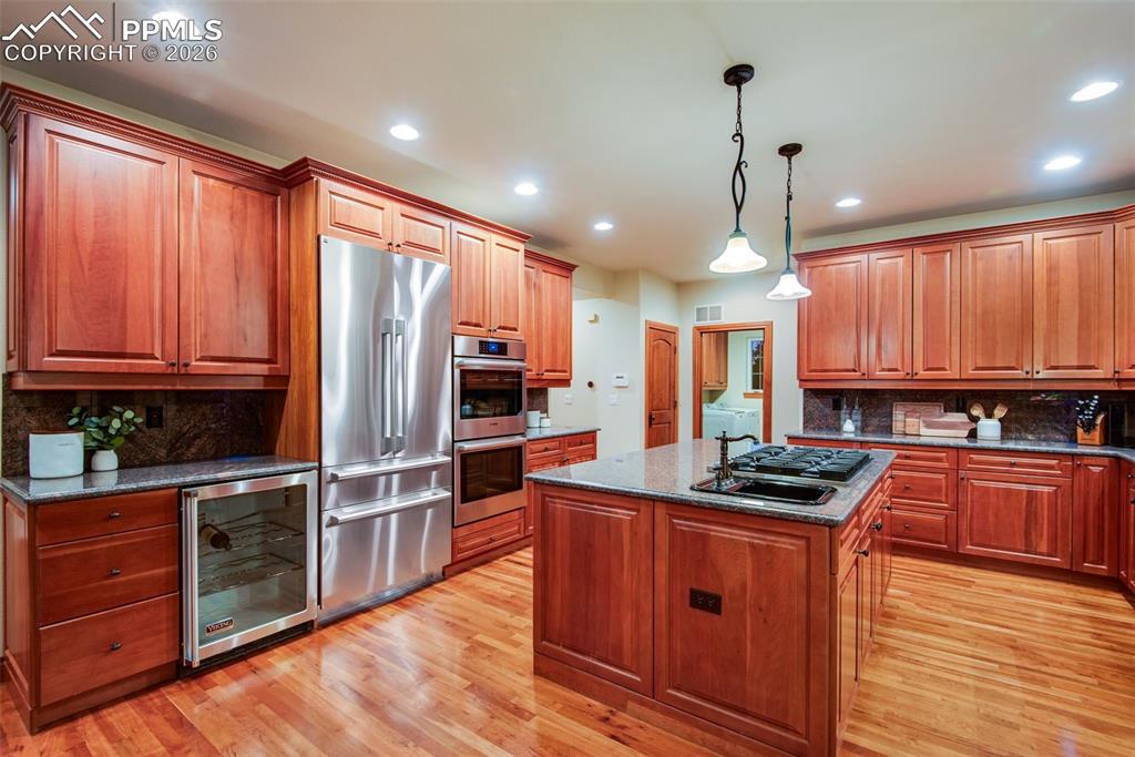 Image 15 of 42: Kitchen with new (2025) built-in refrigerator and updated ovens
