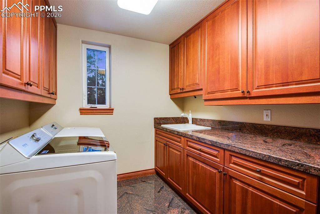 Image 18 of 42: Laundry room located on the main level right off of the garage