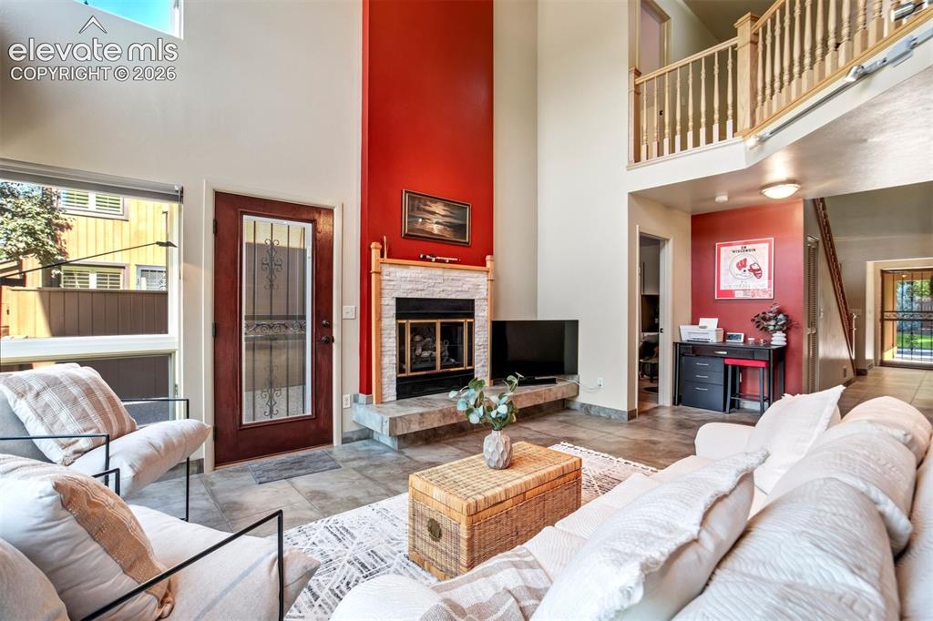 Image 12 of 50: A beautiful stone fireplace that creates a natural gathering space.