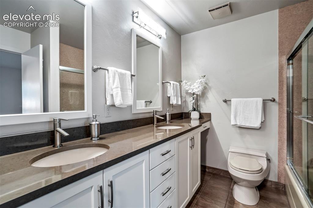 Image 26 of 50: Updated primary bath with quartz countertops