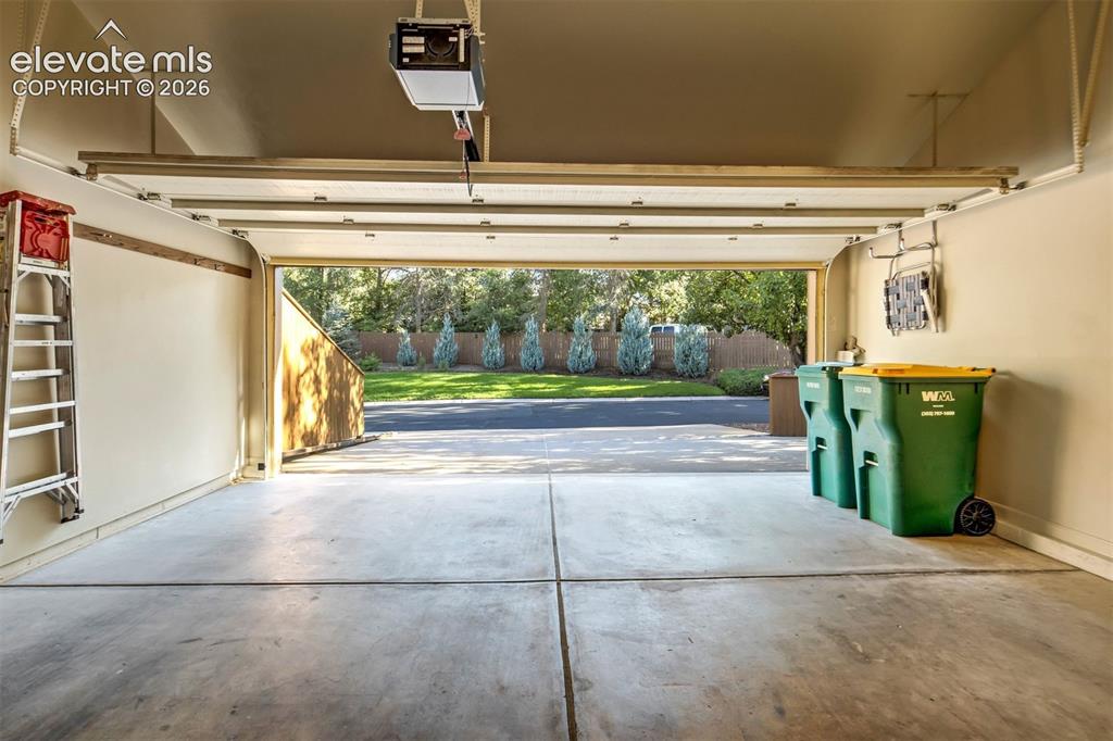 Image 45 of 50: 2 car garage with ample space of storage and includes work bench