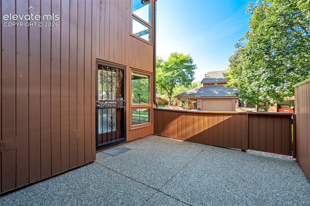 Image 6 of 50: Larger patio off the living room and the primary bedroom