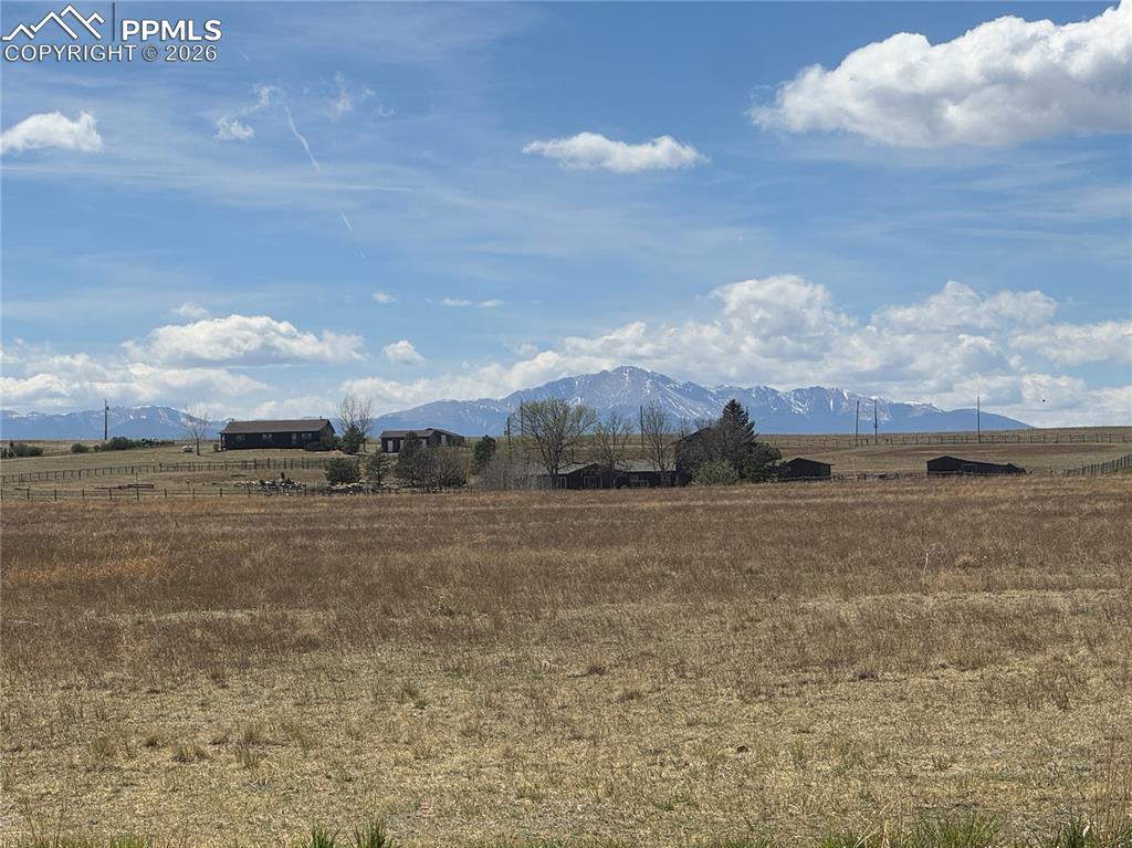 Caption: The property features expansive fields of dry grass and offers distant mountain views