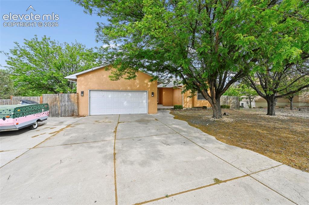 Image 31 of 33: Single-story residence featuring a two-car garage with a white sectional do