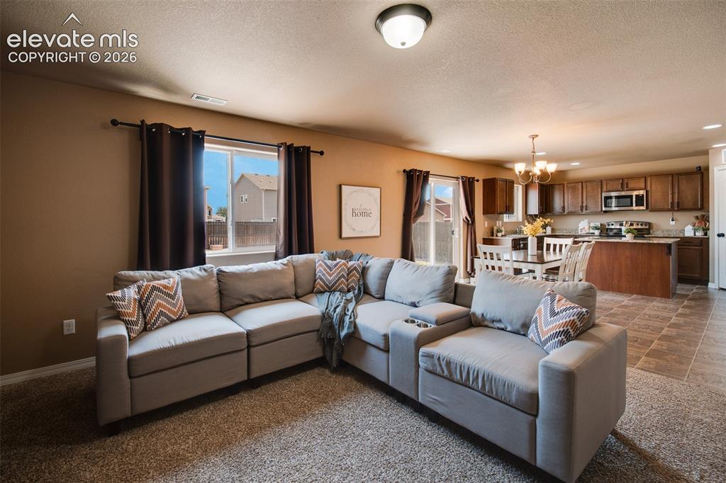 Image 11 of 37: The bright & welcoming family room is filled with natural light & seamlessl