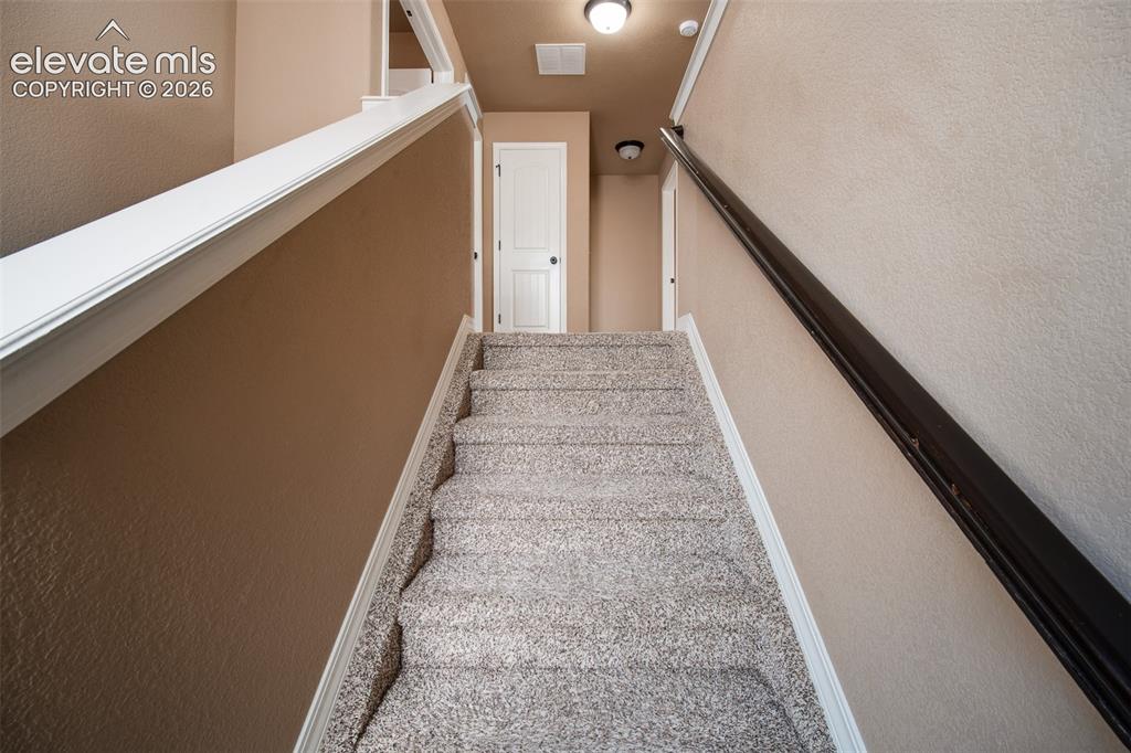 Image 15 of 37: Stairs to the upper level.