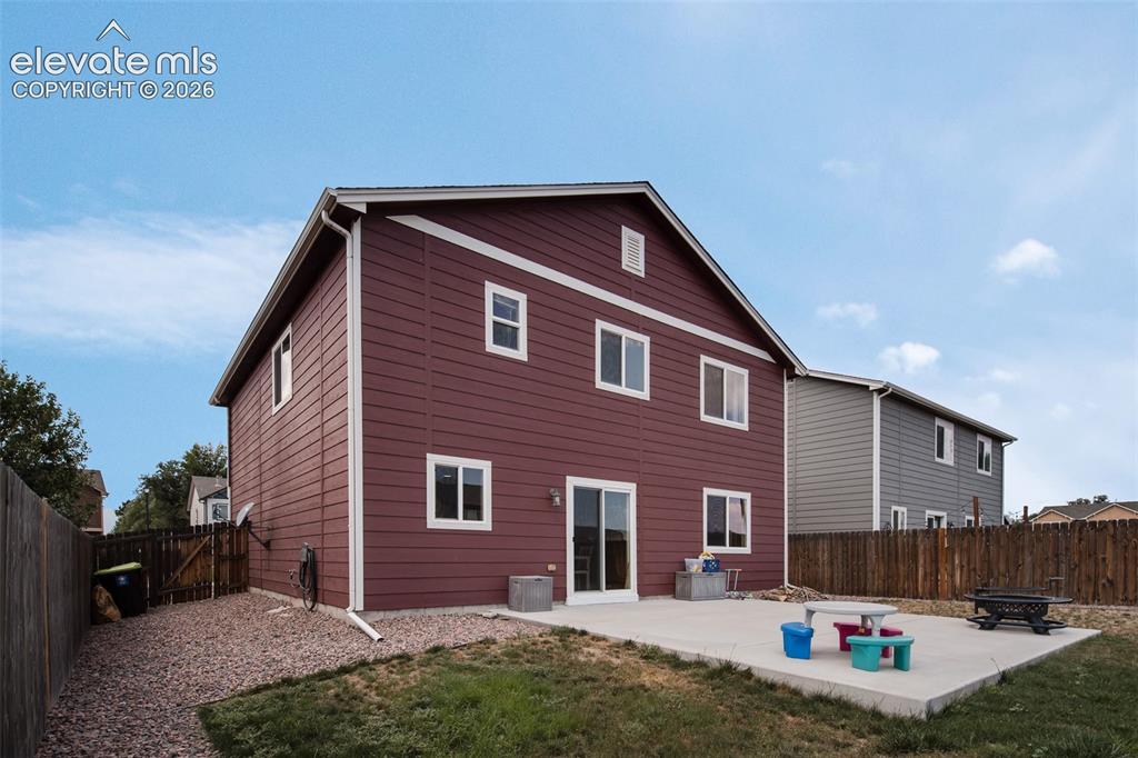 Image 27 of 37: Fenced backyard with concrete patio for outdoor dining and relexation.