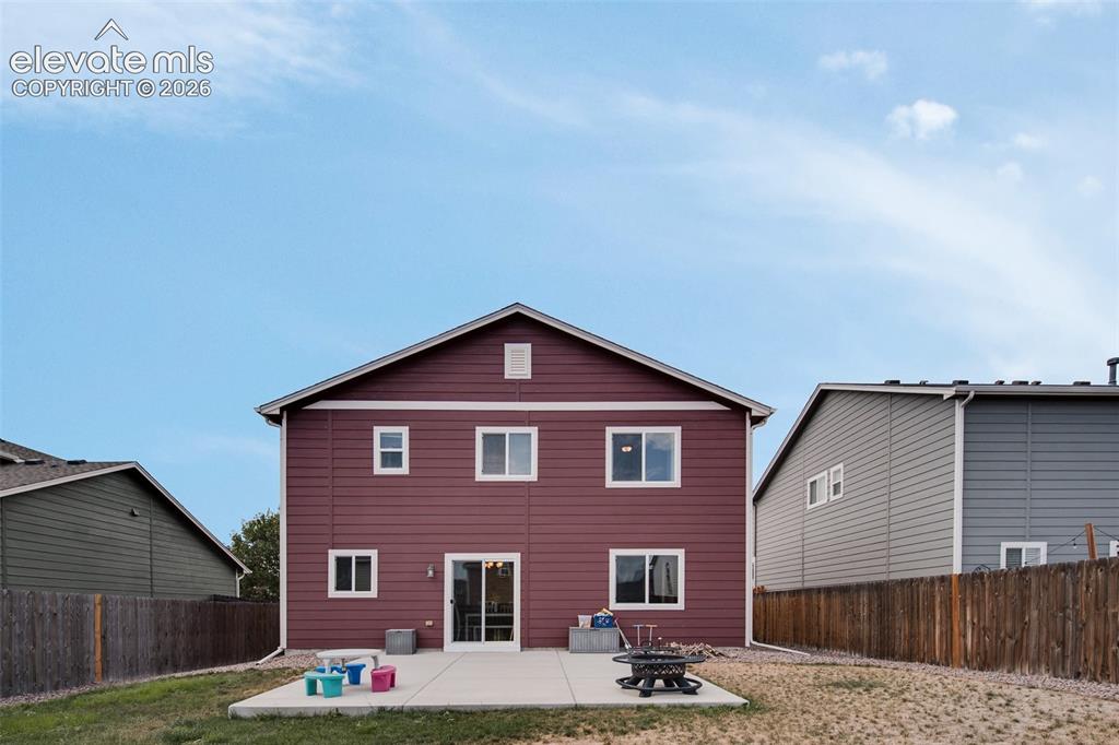 Image 28 of 37: Low maintenance fenced backyard with lots of space for outdoor fun.