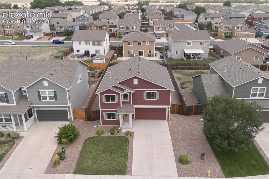 Image 32 of 37: Aerial view of home and front yard.