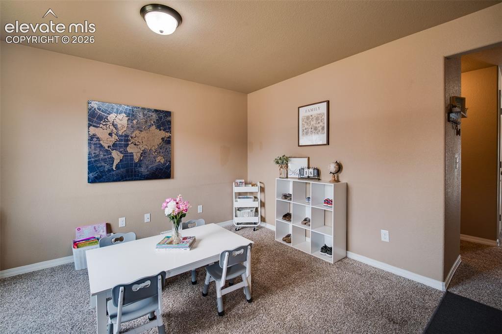 Image 6 of 37: Front Living Room with neutral carpet - currently a home school room.