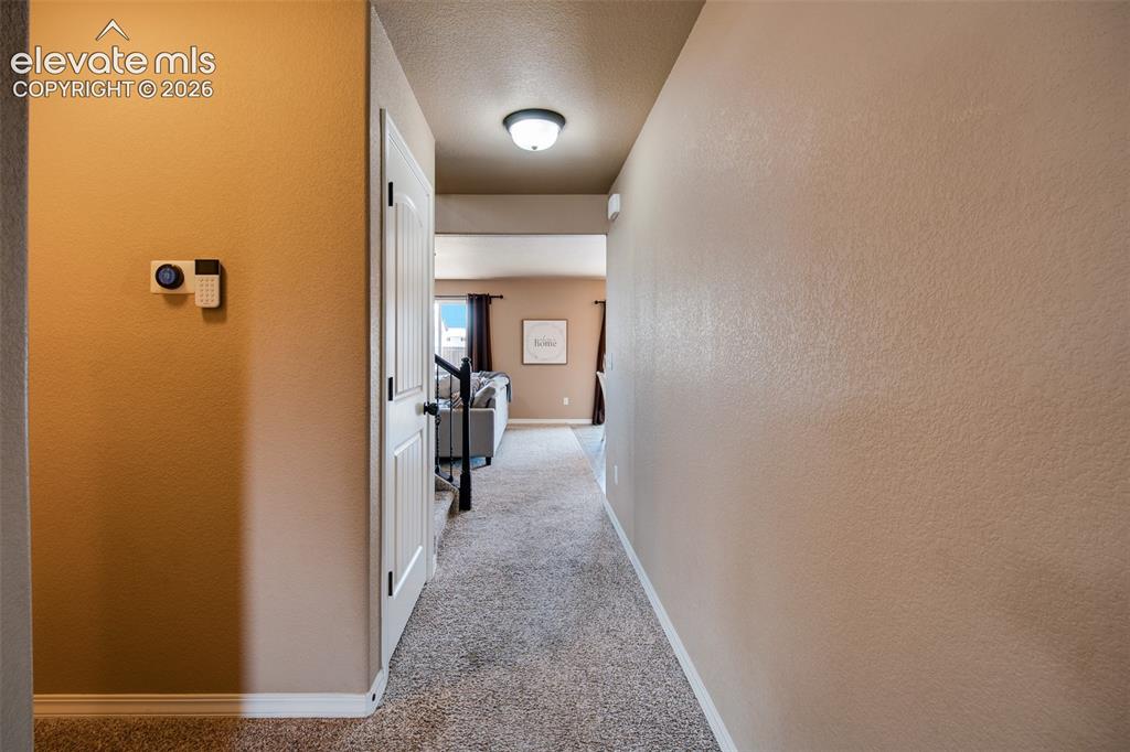 Image 7 of 37: Hallway into the Family Room, Dining Area, and Kitchen.