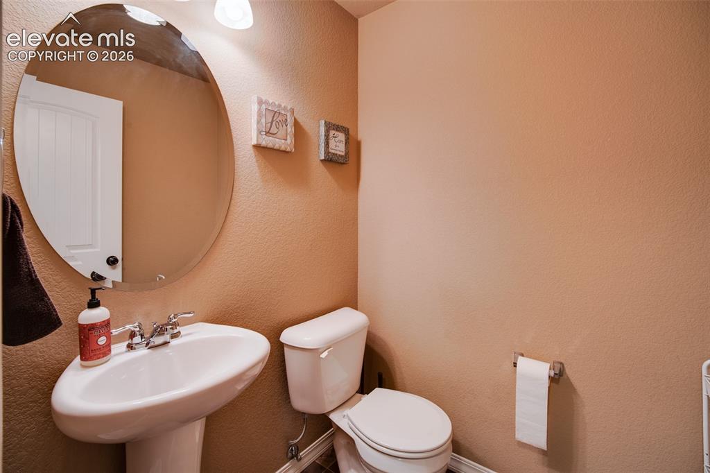 Image 8 of 37: Powder Bathroom with pedestal sink.