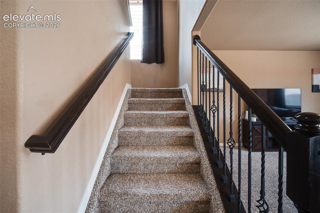Image 9 of 37: Stairs to the upper level.