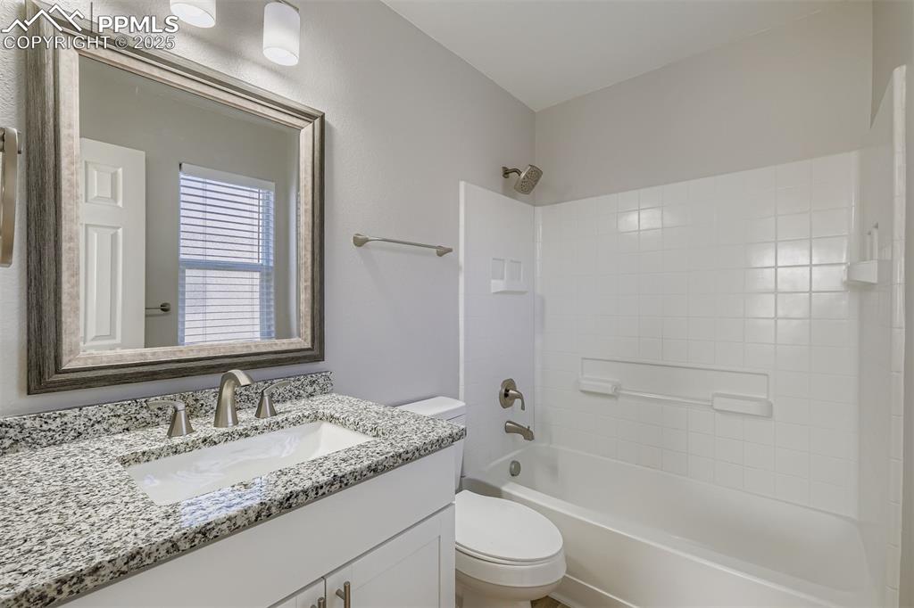 Image 12 of 22: Bathroom featuring vanity and washtub / shower combination