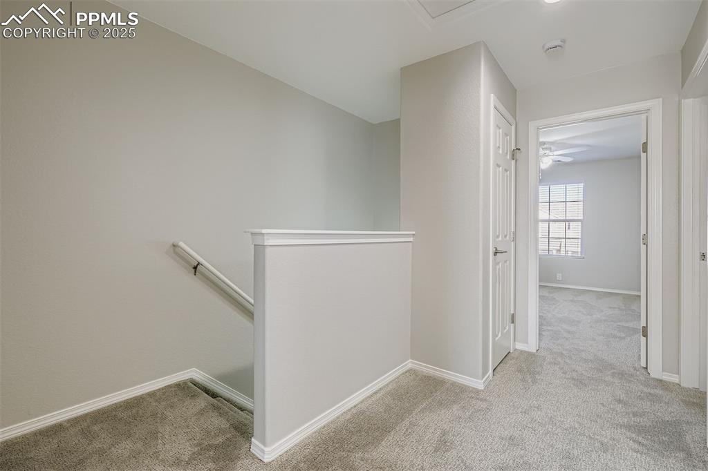 Image 15 of 22: Landing area at top of stairs has a linen closet