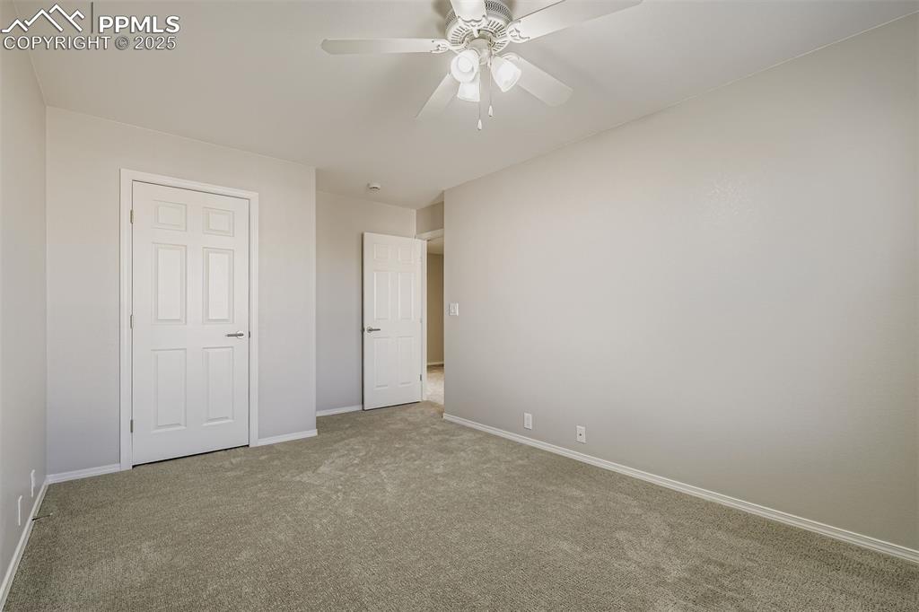 Image 19 of 22: Unfurnished bedroom with carpet floors and ceiling fan
