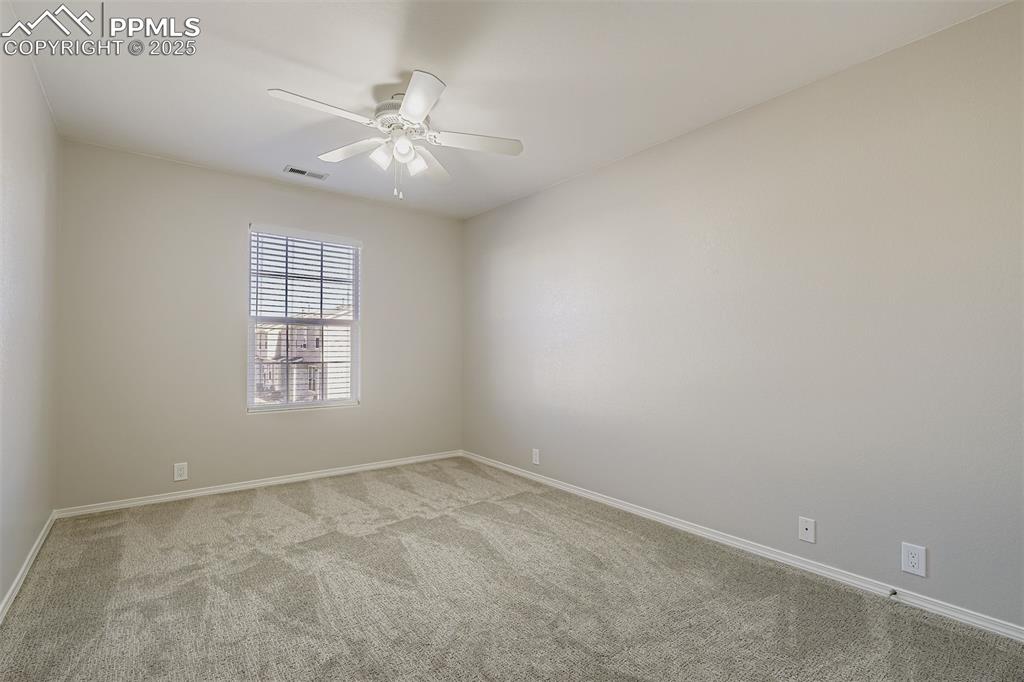 Image 20 of 22: Empty room featuring carpet and ceiling fan