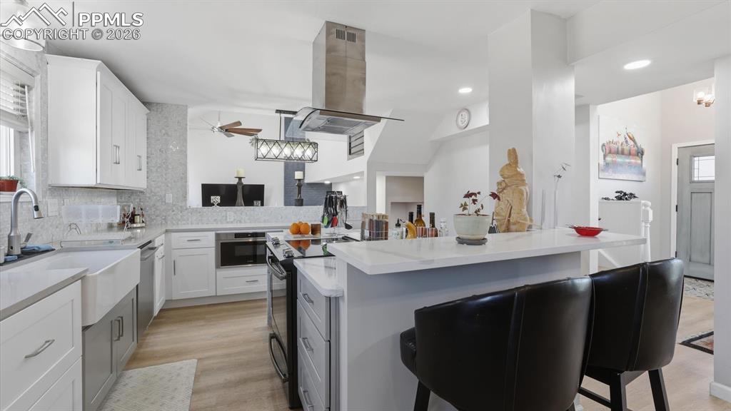 Image 12 of 50: View of the Kitchen and Formal Living Room from the Dining Area.