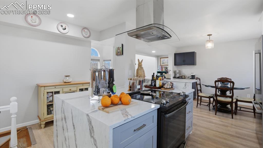 Image 13 of 50: The Kitchen features white cabinetry, quartz countertops and a farm style s