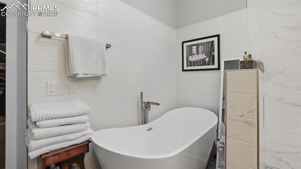 Image 27 of 50: Luxurious 5pc Primary Bathroom with dual sink vanity, round mirrors, walk i