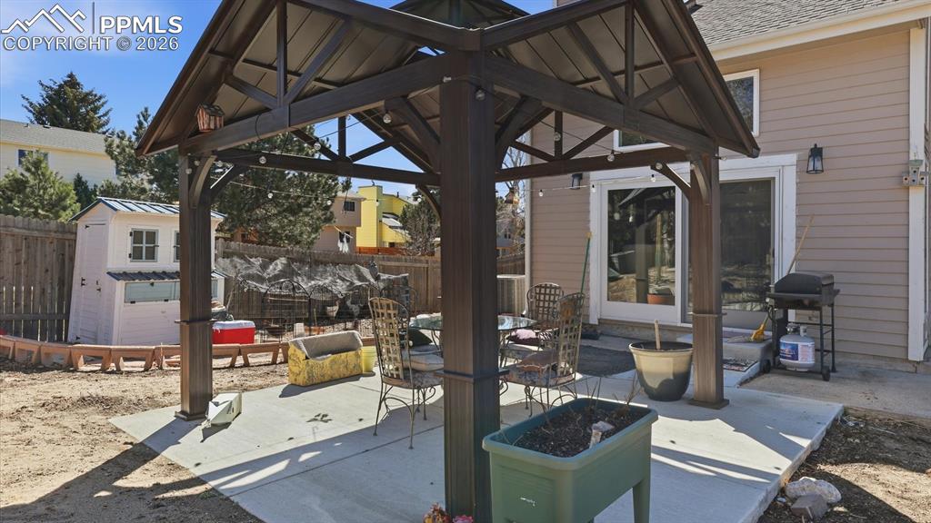 Image 47 of 50: Patio and gazebo for outdoor dining and relaxation.