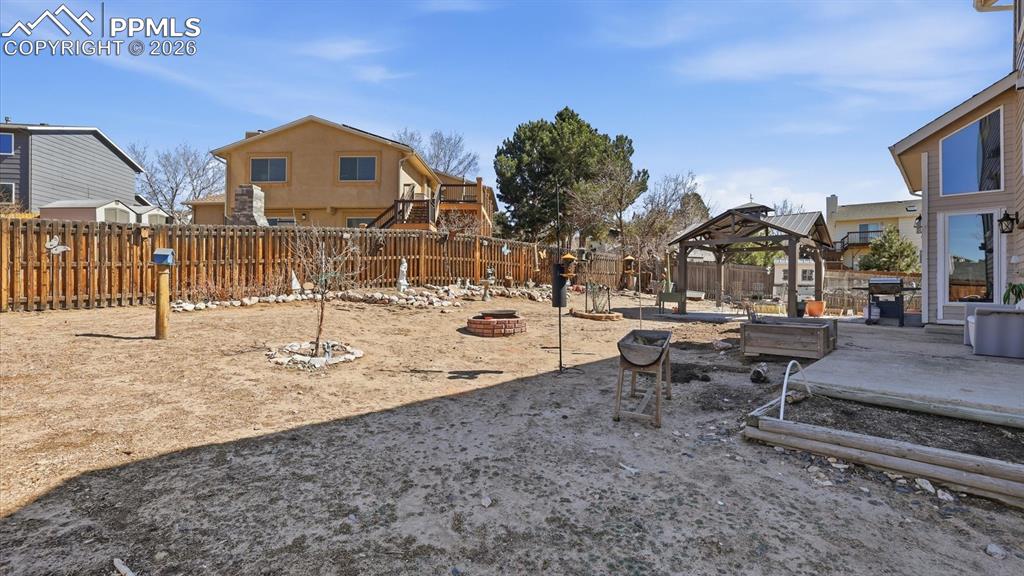 Image 48 of 50: Backyard patio and gazebo.