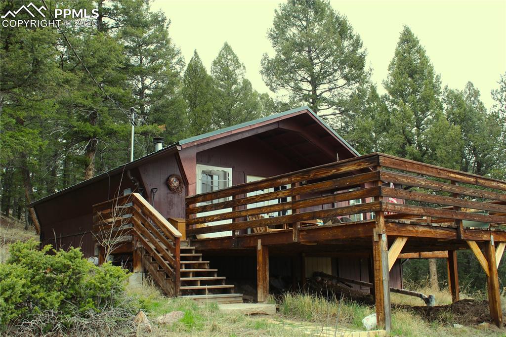 Caption: Front of house with stairs and a deck