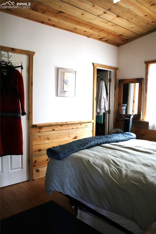 Image 7 of 15: Bedroom featuring wooden ceiling and wood finished floors