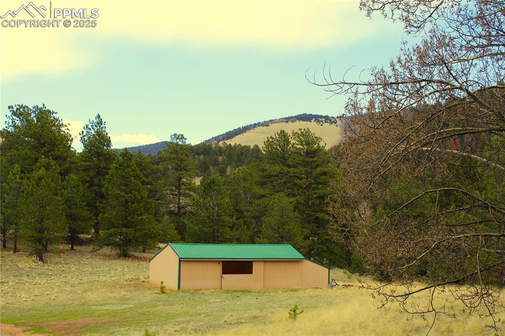 Image 9 of 15: Mountain view with a heavily wooded area