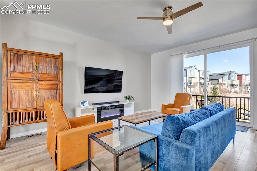 Image 18 of 39: Living room - walkout to deck, recessed lighting, custom wiring for electro