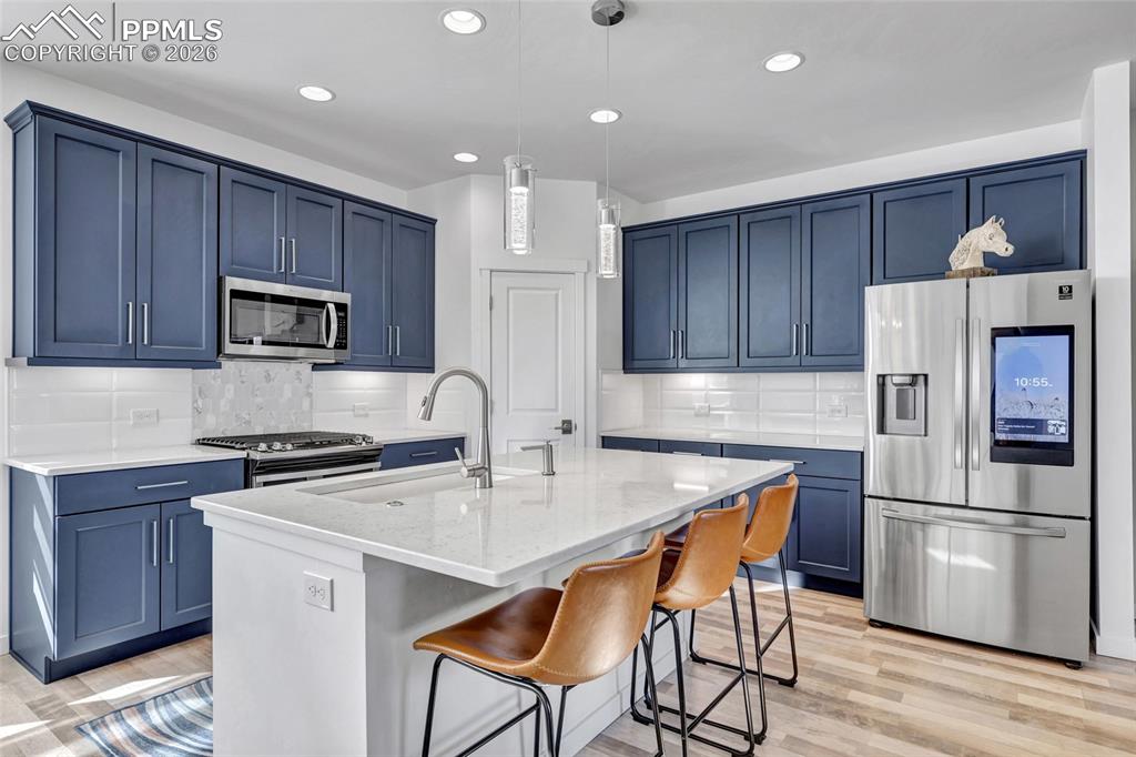Image 2 of 39: Kitchen - Maple cabinets, LVP floors, quartz countertops, recessed lighting