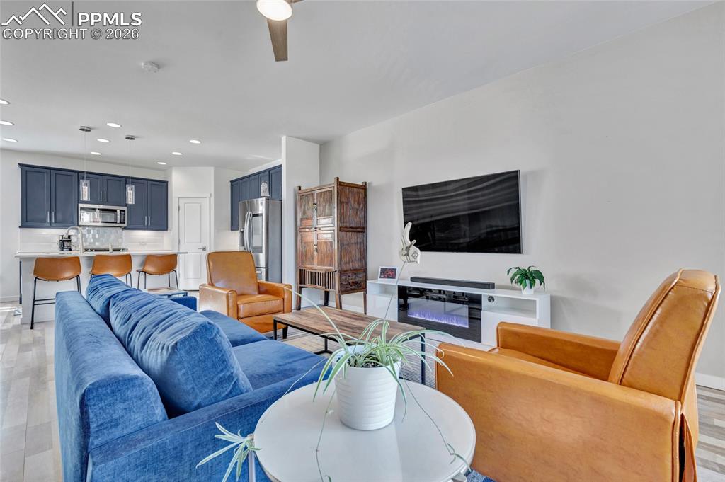 Image 21 of 39: Living room - walkout to deck, recessed lighting, custom wiring for electro