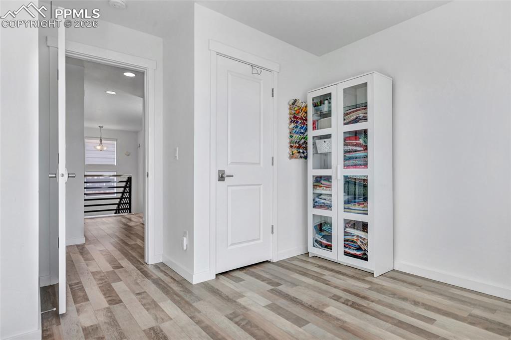 Image 31 of 39: Bedroom - LVP floors, Zebra window coverings, view of Pikes Peak