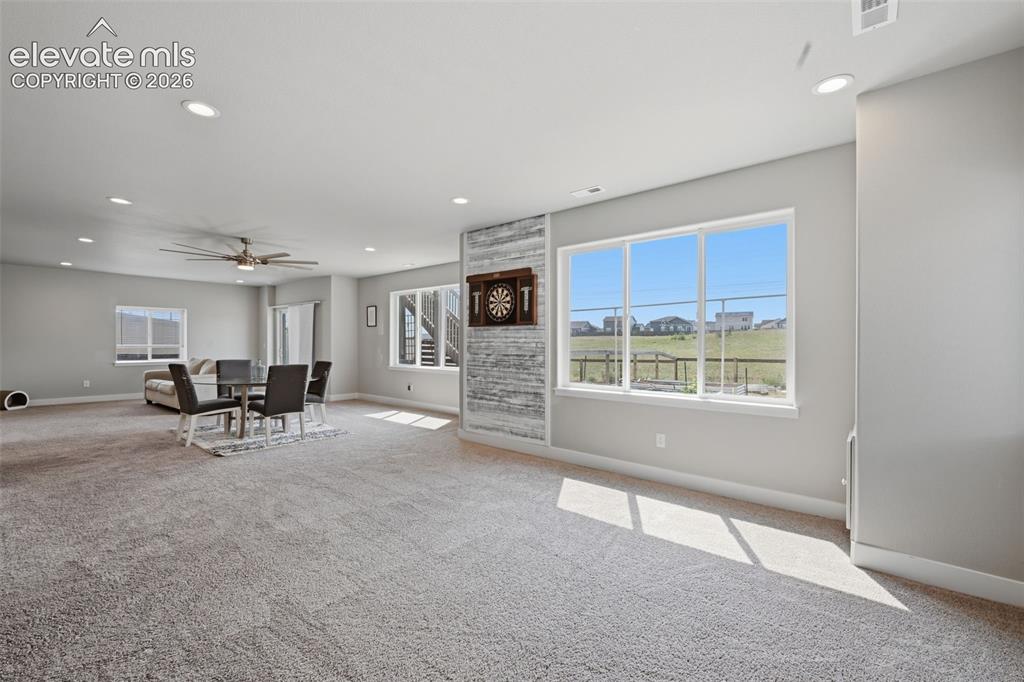 Image 23 of 31: Another view of the family room. The door on the left is the entrance to th